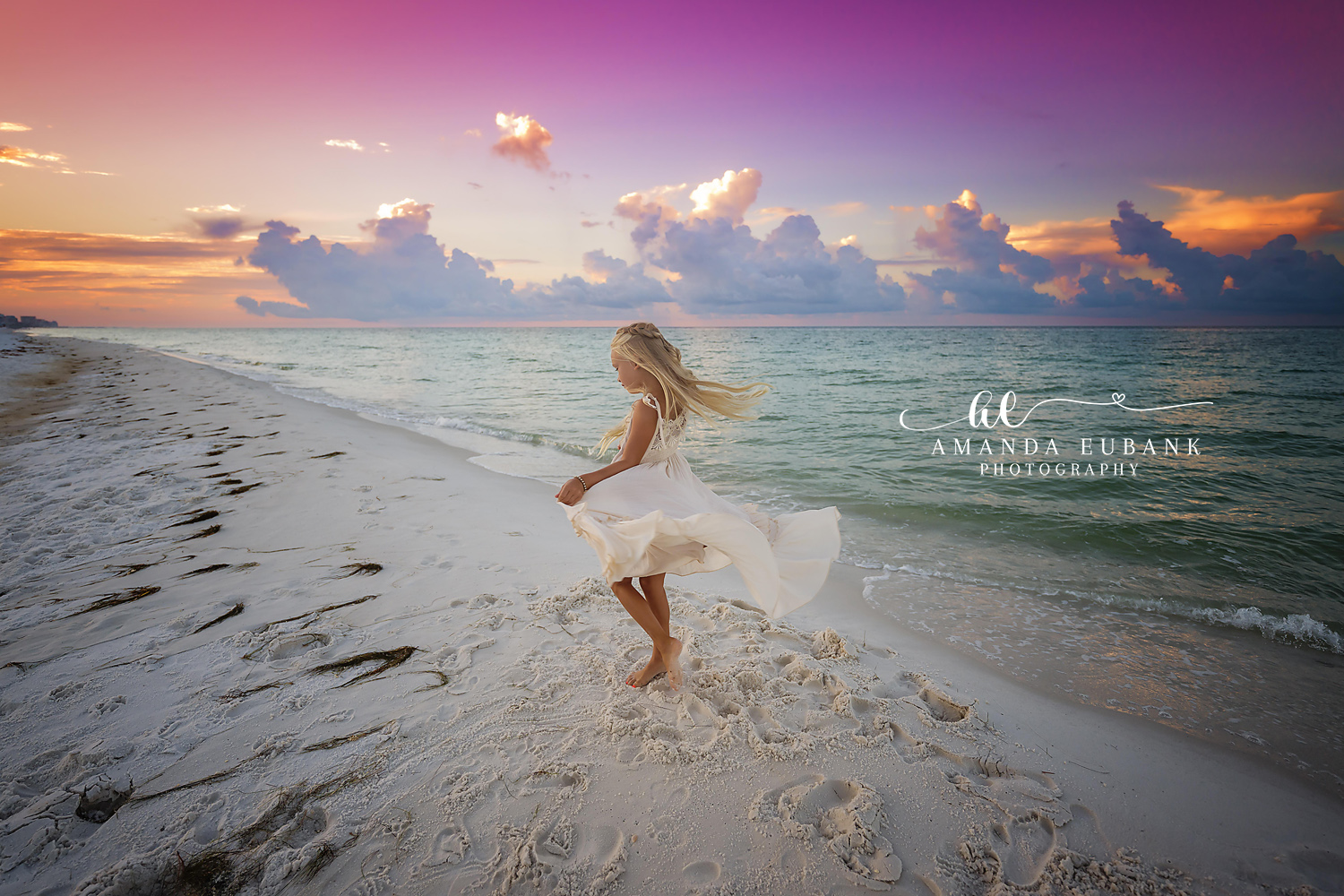 Santa Rosa Beach Family Photographer – Girl Twirling on the Beach at Sunset Young girl with long blonde hair twirling on the beach at sunset in a flowing cream dress that swirls around her, photographed by a Santa Rosa Beach family photographer